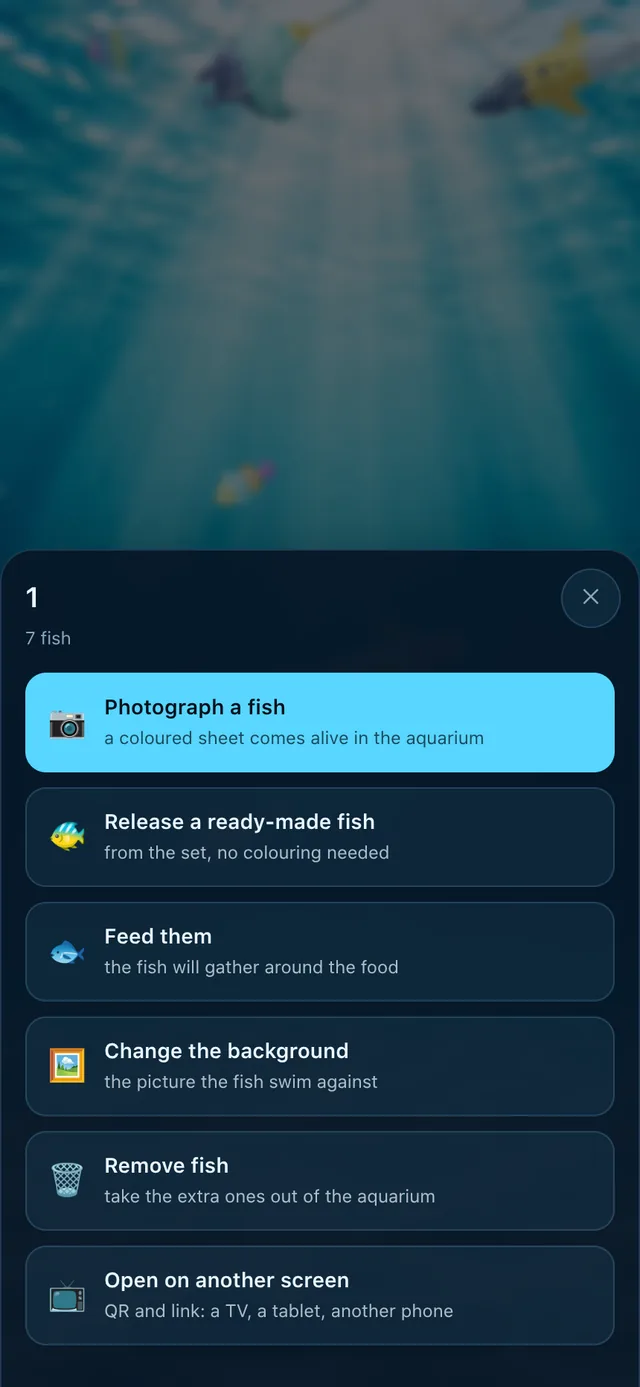 The aquarium's menu on a phone: photograph a fish, release a ready-made one, feed them, change the background